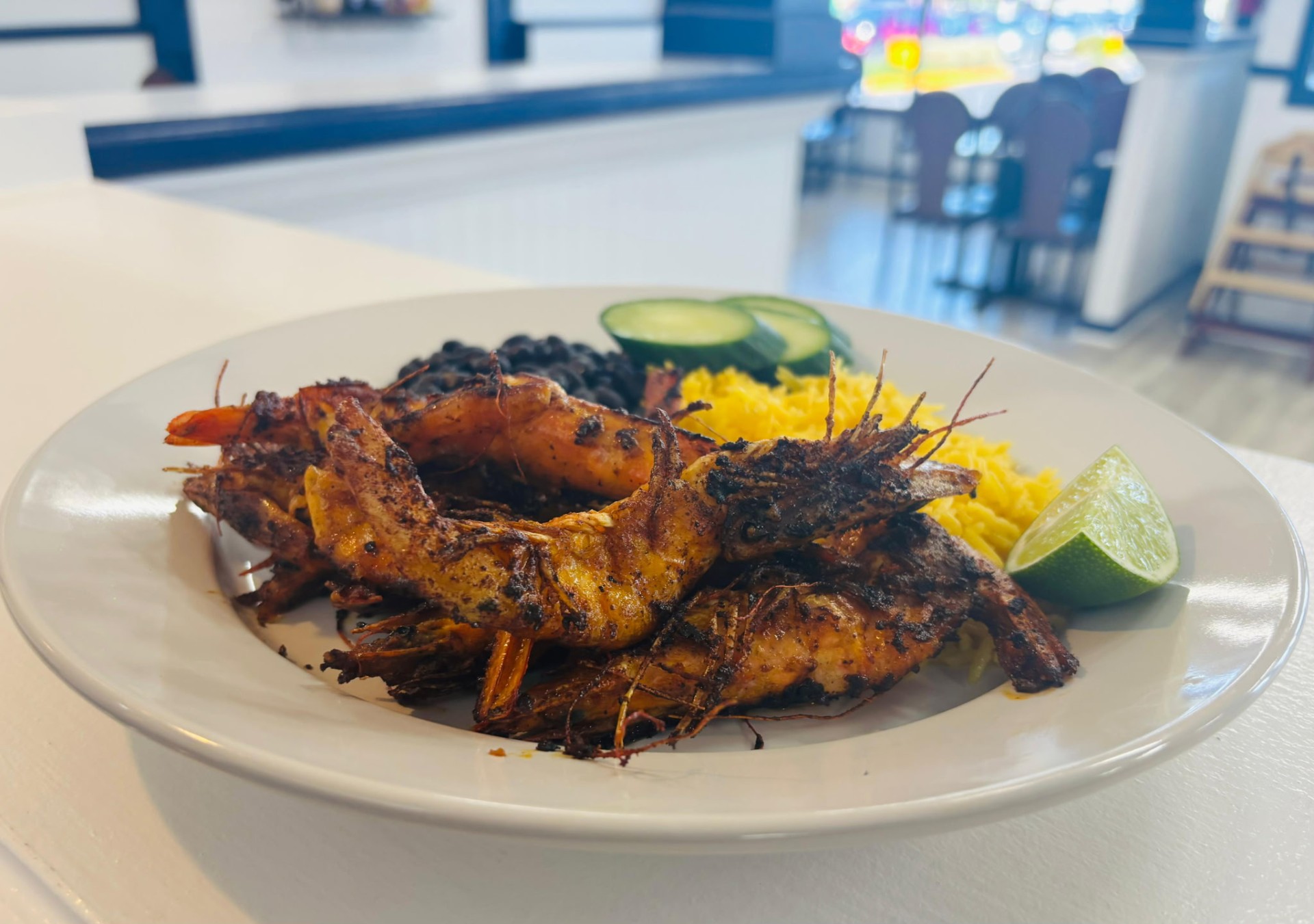 Grilled head-on shrimp with yellow rice and black beans