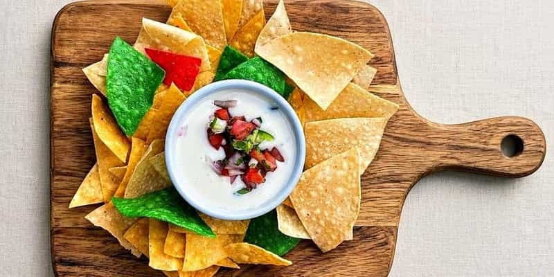 Tri-color tortilla chips with queso and pico de gallo
